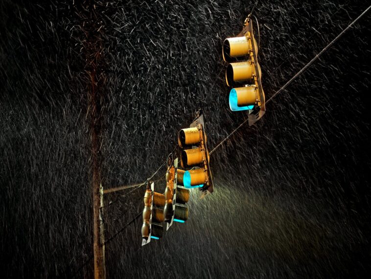 four traffic lights under the rain