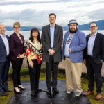 Nathan Cullen, Minister of Water, Land and Resource Stewardship; Jennifer Rice, Parliamentary Secretary for Rural Health; K̓áwáziɫ Marilyn Slett, Chief Councillor of the Heiltsuk Nation and President of Coastal First Nations; Premier David Eby; Dallas Smith, President of Nanwakolas Council; and Eddy Adra, CEO of Coast Funds at the funding announcement in Vancouver.