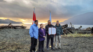 Gary Anandasangaree, Judi Thomas, Jeff Jones, and Dave Tovell, sign an agreement to return the use of ?A:?b?e:?s | Middle Beach to Pacheedaht First Nation near Port Renfrew, BC.