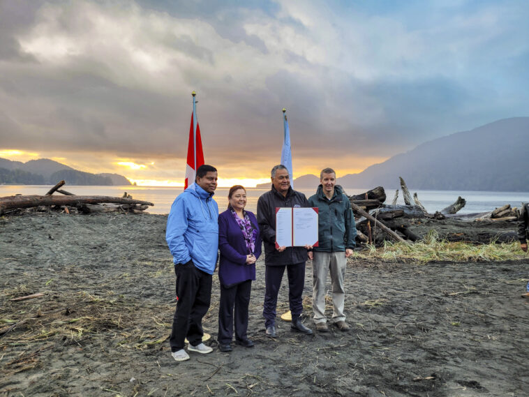 Gary Anandasangaree, Judi Thomas, Jeff Jones, and Dave Tovell, sign an agreement to return the use of ?A:?b?e:?s | Middle Beach to Pacheedaht First Nation near Port Renfrew, BC.