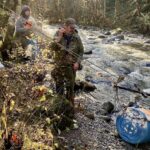 Volunteers with the Courtenay Fish and Game club transport live coho salmon out of the Trent River canyon with their "salmon skyline."