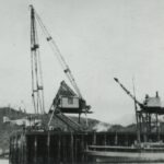 View of one of the Douglas World Cruiser aircraft being hoisted out of the water for repairs at Prince Rupert, BC, in April 1924.