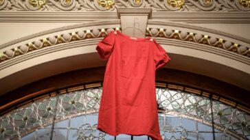 A red dress hung over an arch at a government building