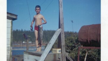 A proud 9-year-old Michel Drouin poses with his catch of the day.