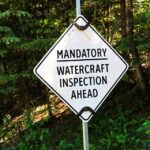 A sign that reads "mandatory watercraft inspection ahead"