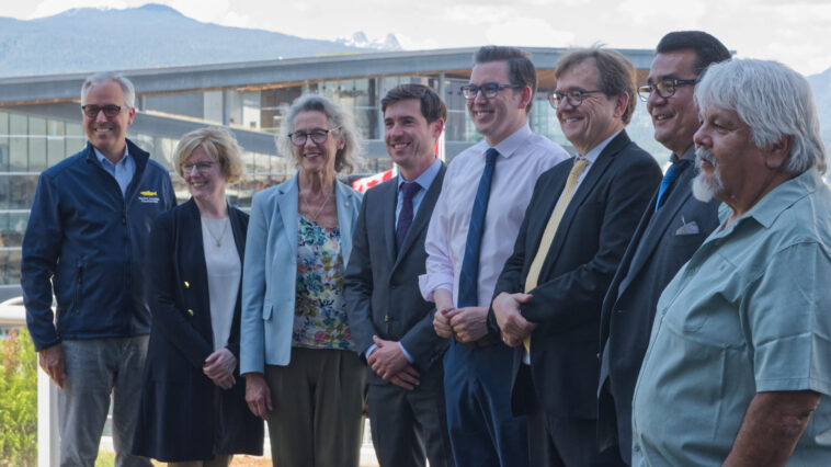 Representatives from the BC government and Federal government with BC-based spokespersons pose for a photo at the government's announcement of BC's fish farm transition transition plan.