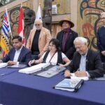 Assembled leaders and elected officials sign landmark agreement with two First Nations