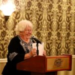 Linda Lutz stands at a podium at an event awarding grants to community organizations in Prince Rupert BC