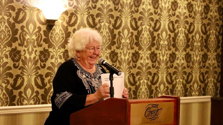 Linda Lutz stands at a podium at an event awarding grants to community organizations in Prince Rupert BC