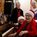 Charlotte Rowse played Christmas jingles on her piano while the crowd sang along during her annual women's sherry party on Dec. 6 at Acropolis Manor.