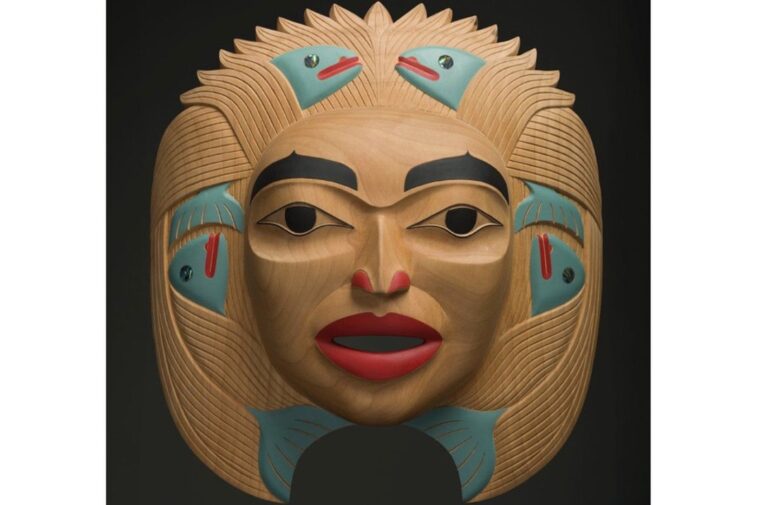 Dale Campbell's "Woman who Brought the Salmon" mask made of alder, abalone and pigment.